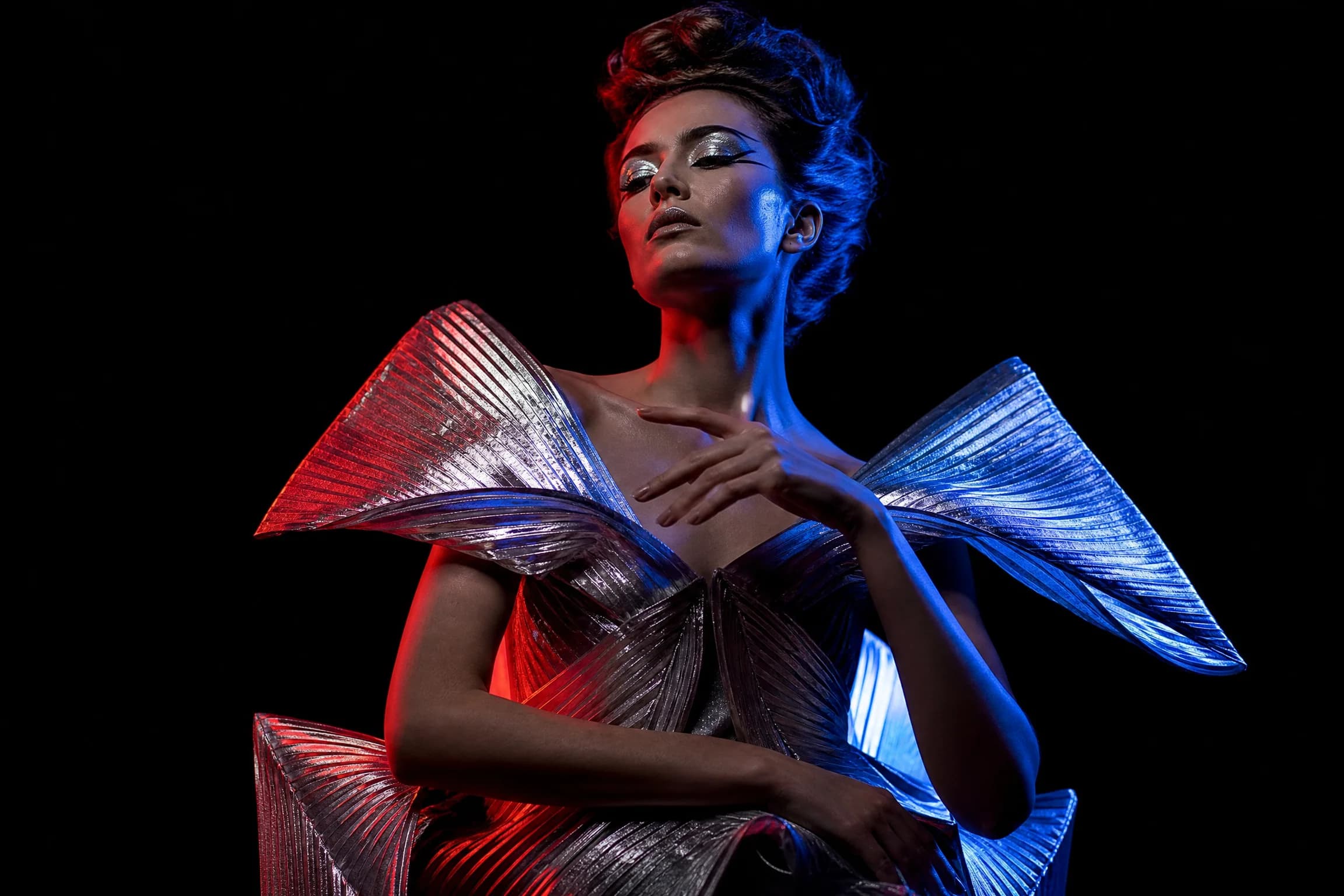 Before and after comparison of avant-garde fashion editorial portrait with dramatic split lighting - after