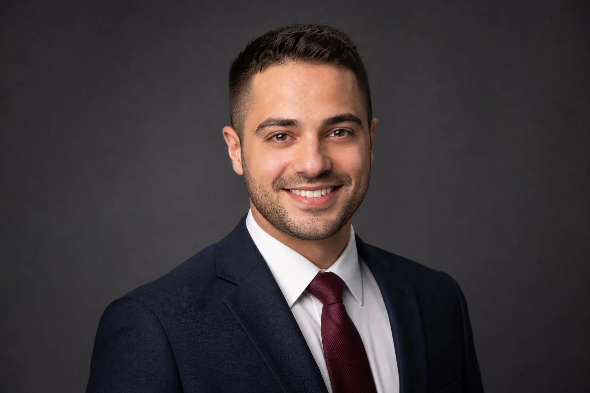 Before and after comparison of professional corporate headshot transformation from bathroom selfie - after