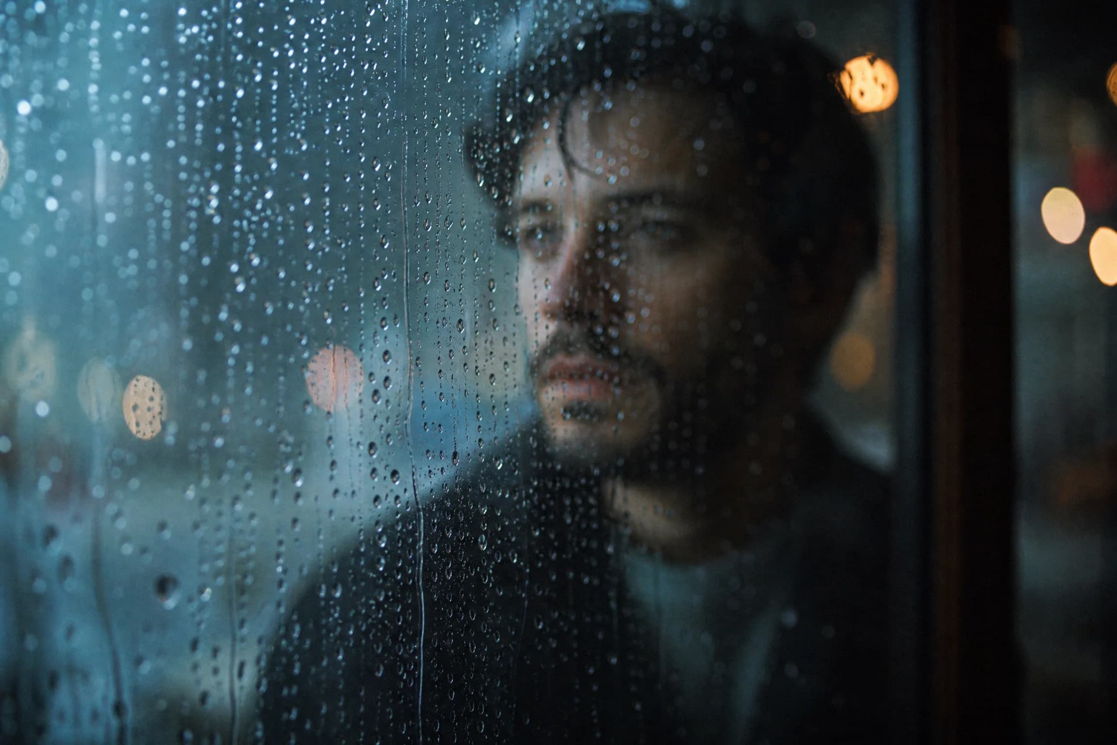 Before and after comparison of cinematic rainy window portrait with bokeh raindrops and moody atmosphere - after