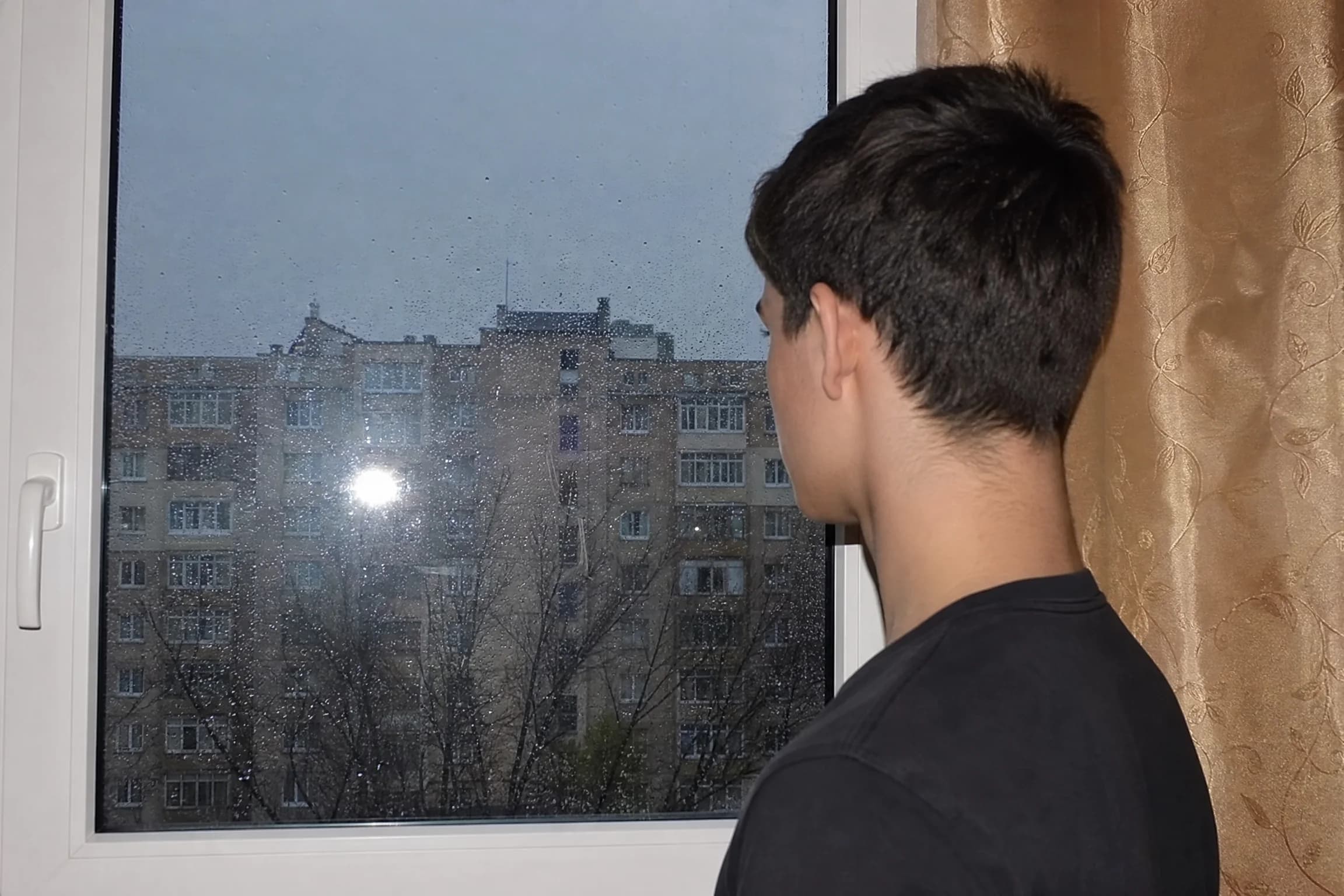 Before and after comparison of cinematic rainy window portrait with bokeh raindrops and moody atmosphere - before